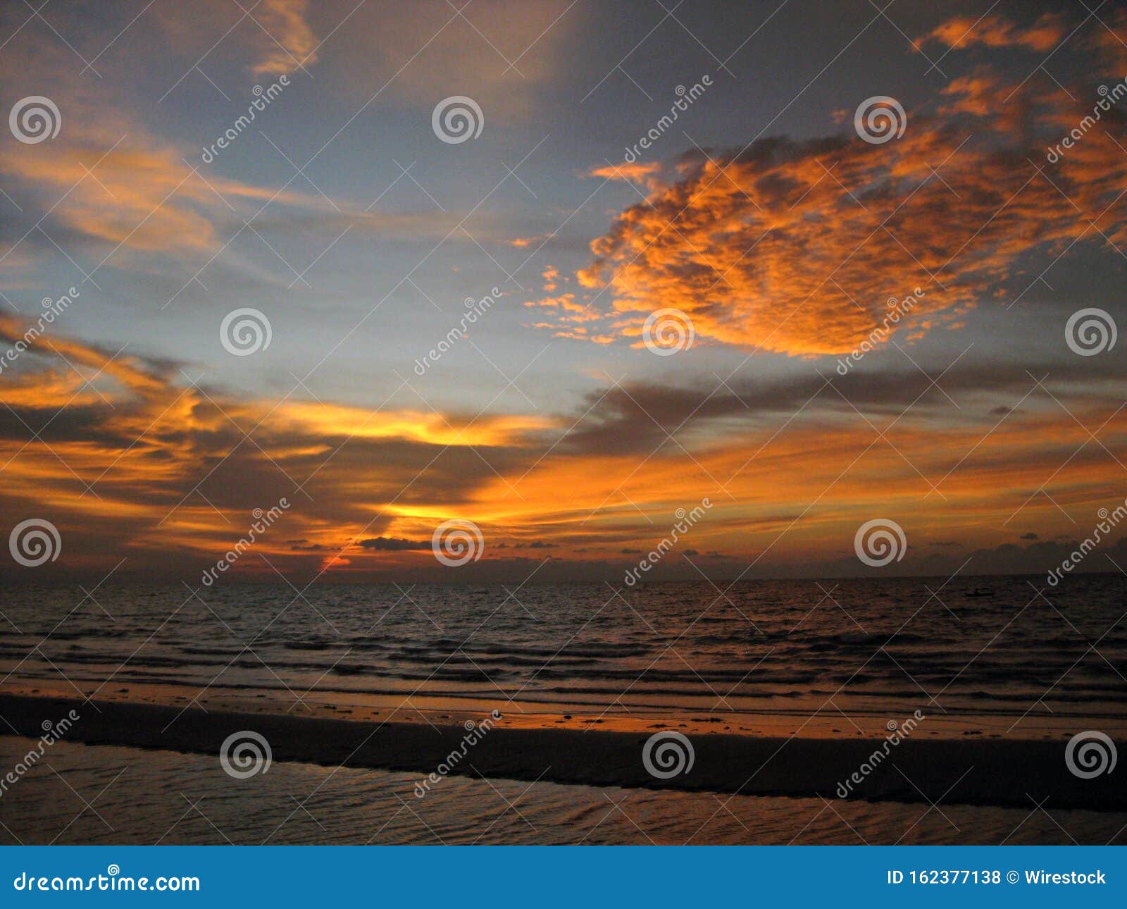 Breathtaking Scenery Of The Sunset Sky Over Gold Colored Clouds