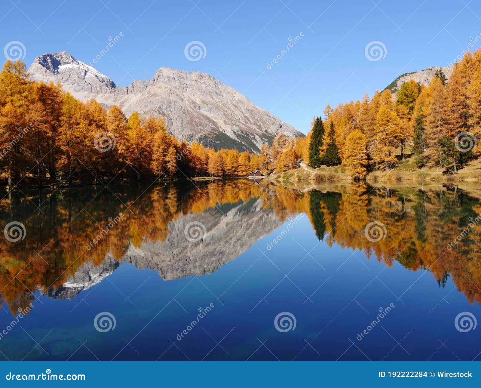 breathtaking shot of a reflective lake on a mountain landscape background