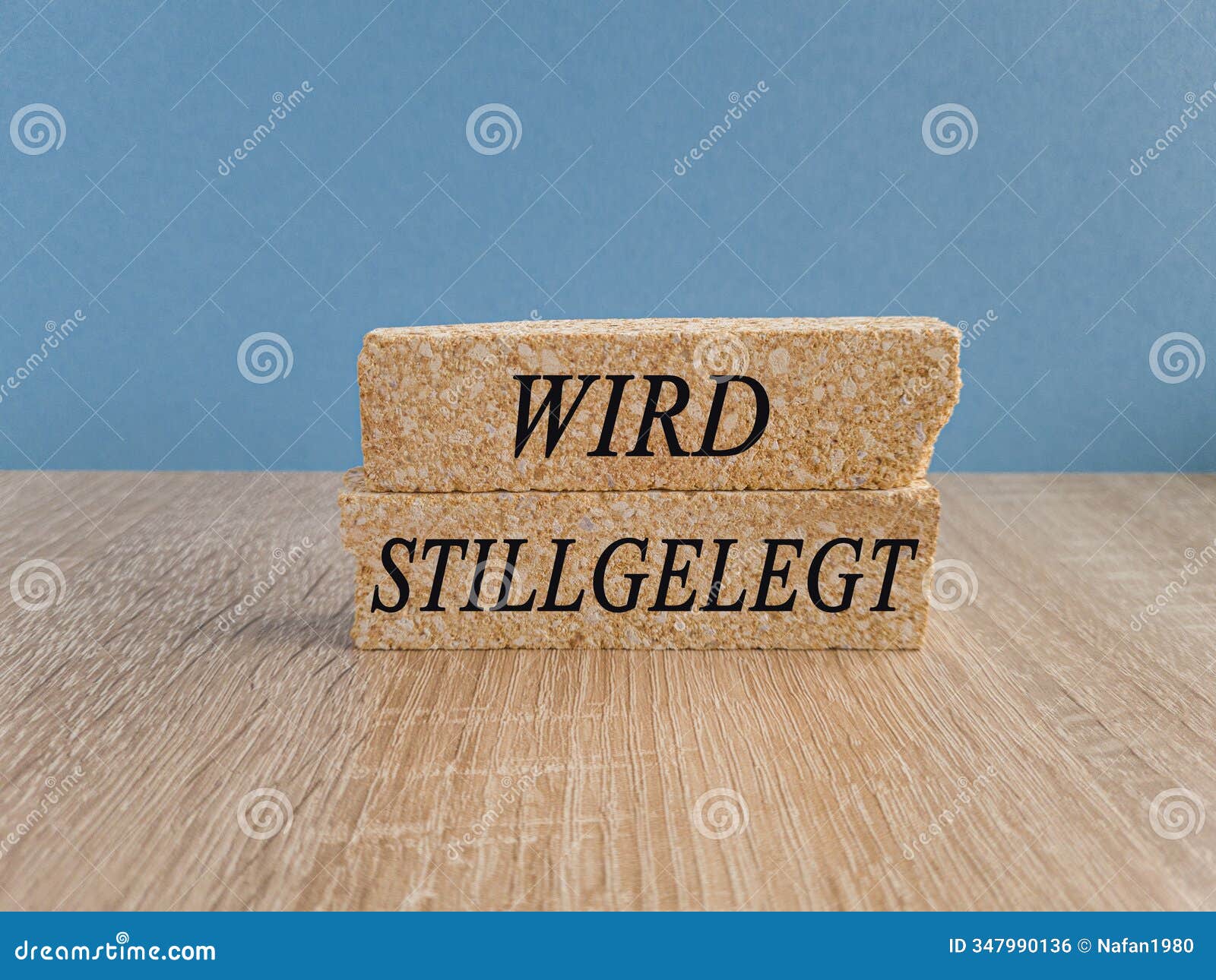 brick blocks with the german text wird stillgelegt -will be decommissioned on blue background.