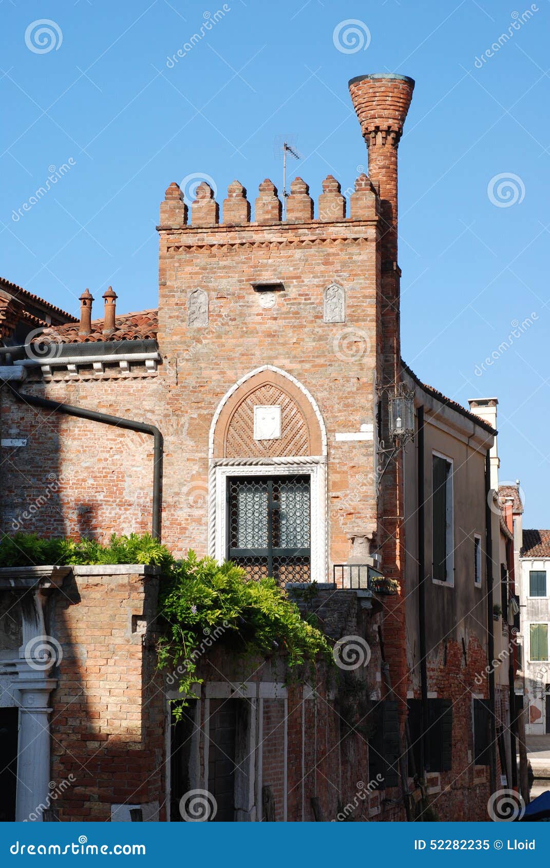 The brick house with a flue on the street of Venice. Italy.