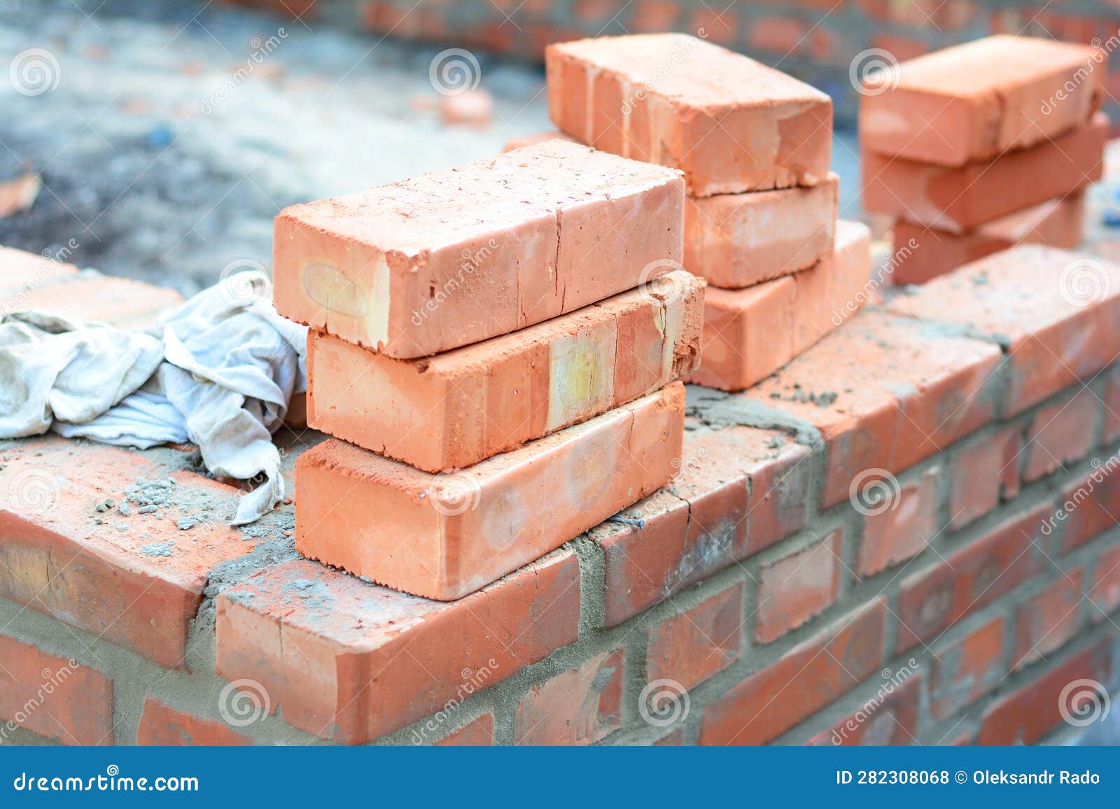 brick house wall constuction with stack of red bricks. building house brick wall concept