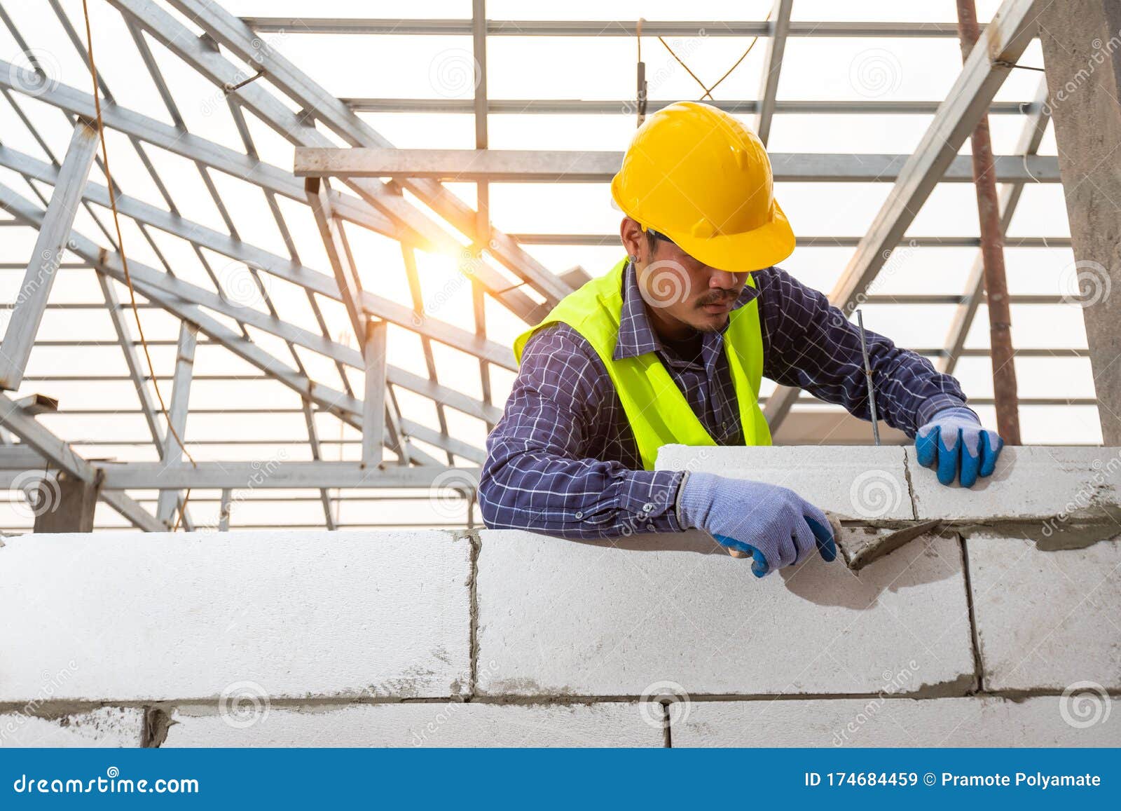 Bricklayer Builder Working with Autoclaved Aerated Concrete Blocks