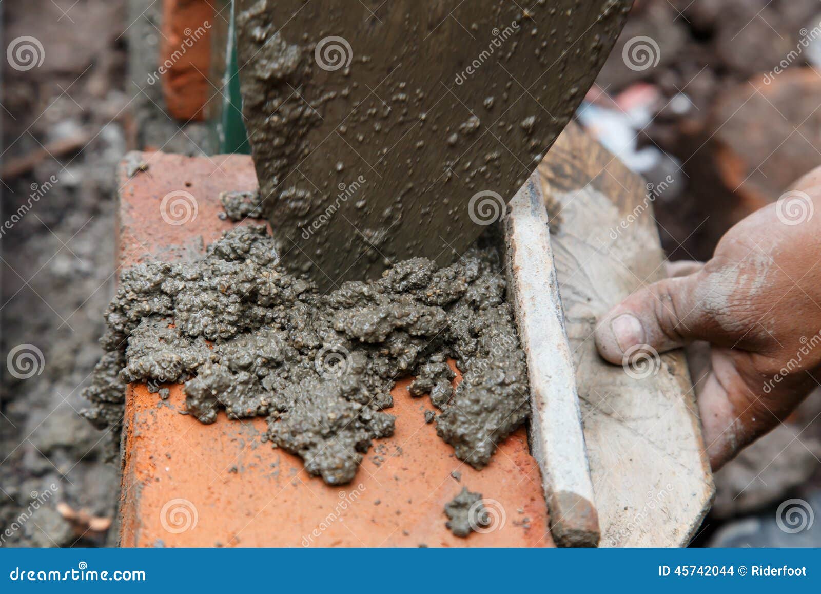 Bricklayer Building a House Using Tools and Cement Stock Photo - Image