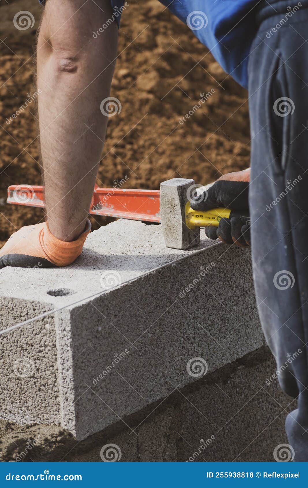 Bricklayer in Glove Spreading Concrete To Build a Wall on Construction