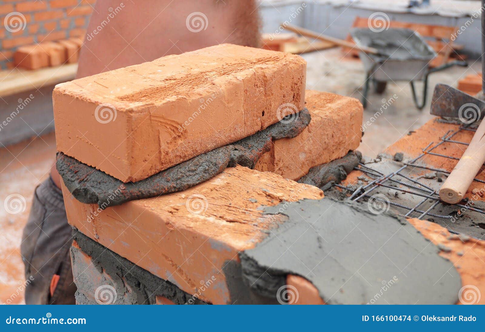 Bricklayer Laying Brick Wall. Close Up on Bricklaying Stock Photo