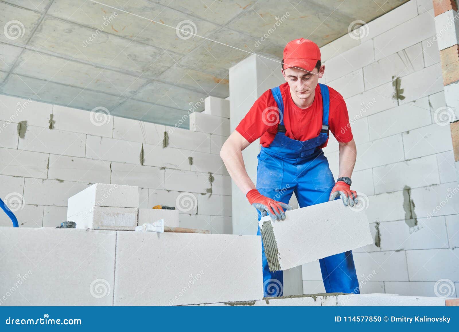 Bricklayer Builder Working With Autoclaved Aerated Concrete Blocks