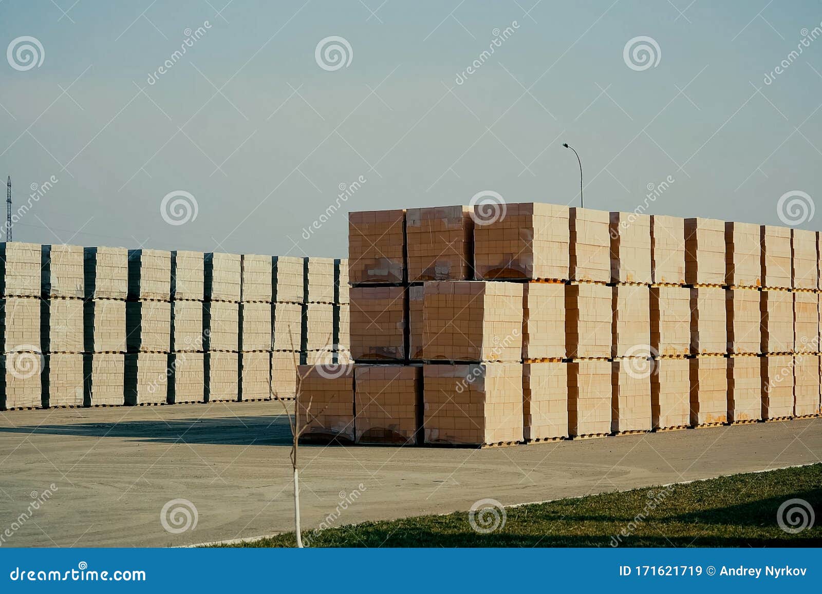 Bricks are Stored in an Open Air Warehouse. Red Brick in Pallets Stock