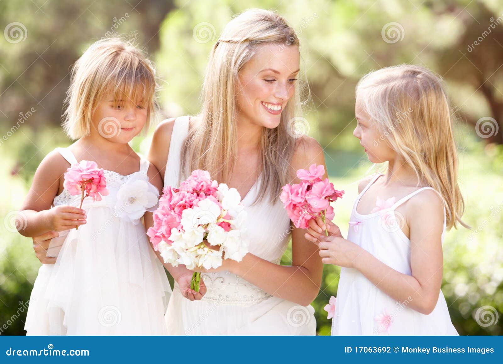 bride with bridesmaids outdoors at wedding