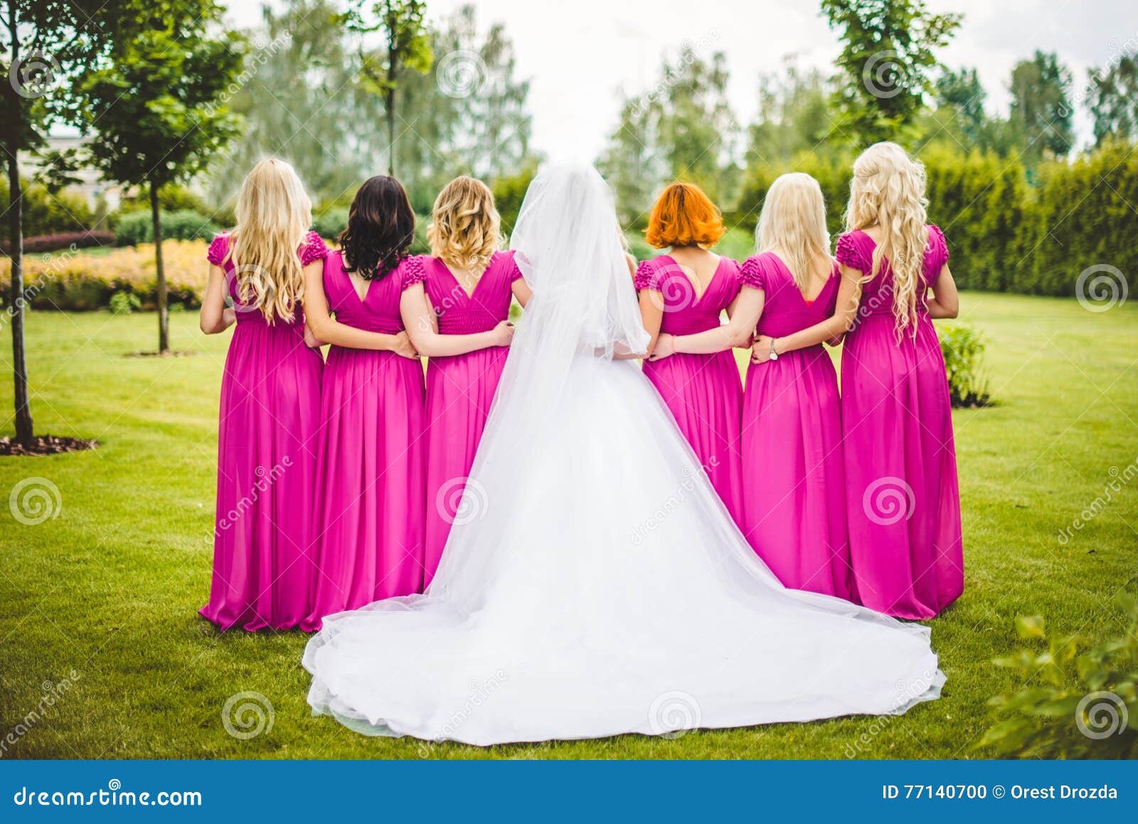 bride with bridesmaids in a park