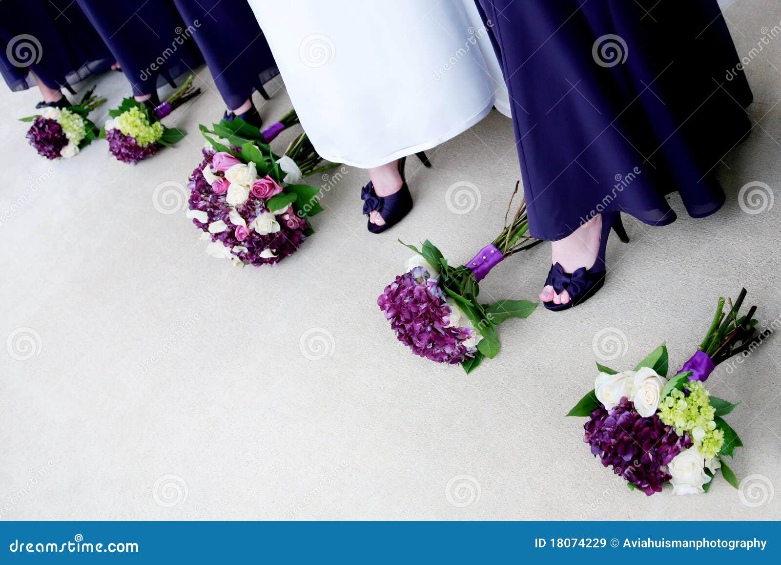 bride with bridesmaids showing off shoes