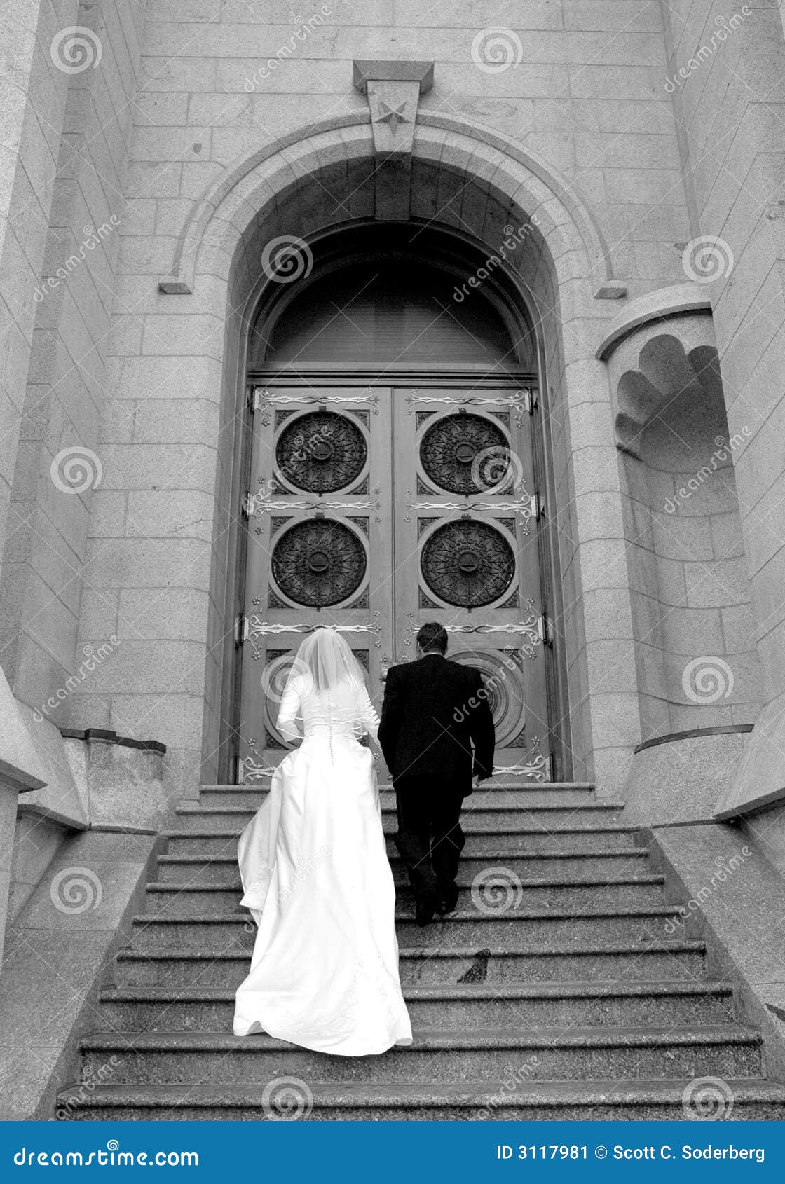 bride and groom ascend stairs