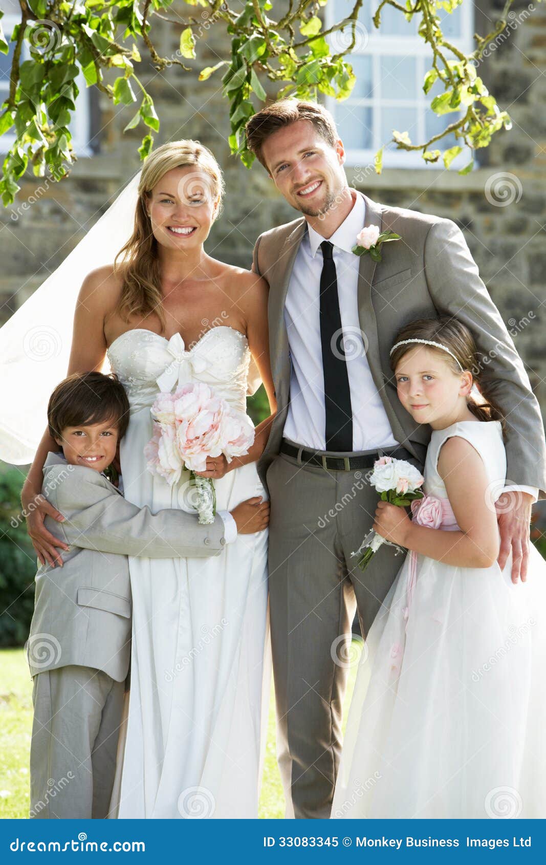 Bride and Groom with Bridesmaid and Page Boy at Wedding Stock Image