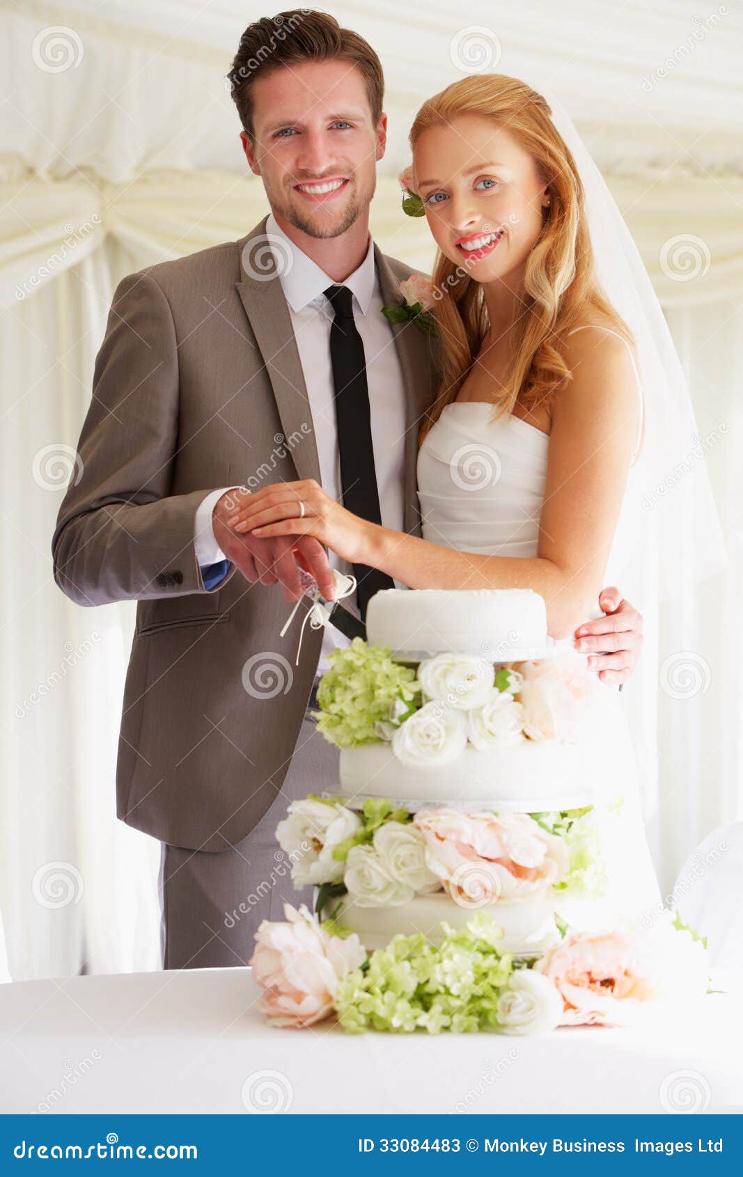 Bride And Groom Cutting  Wedding  Cake  At Reception Stock 