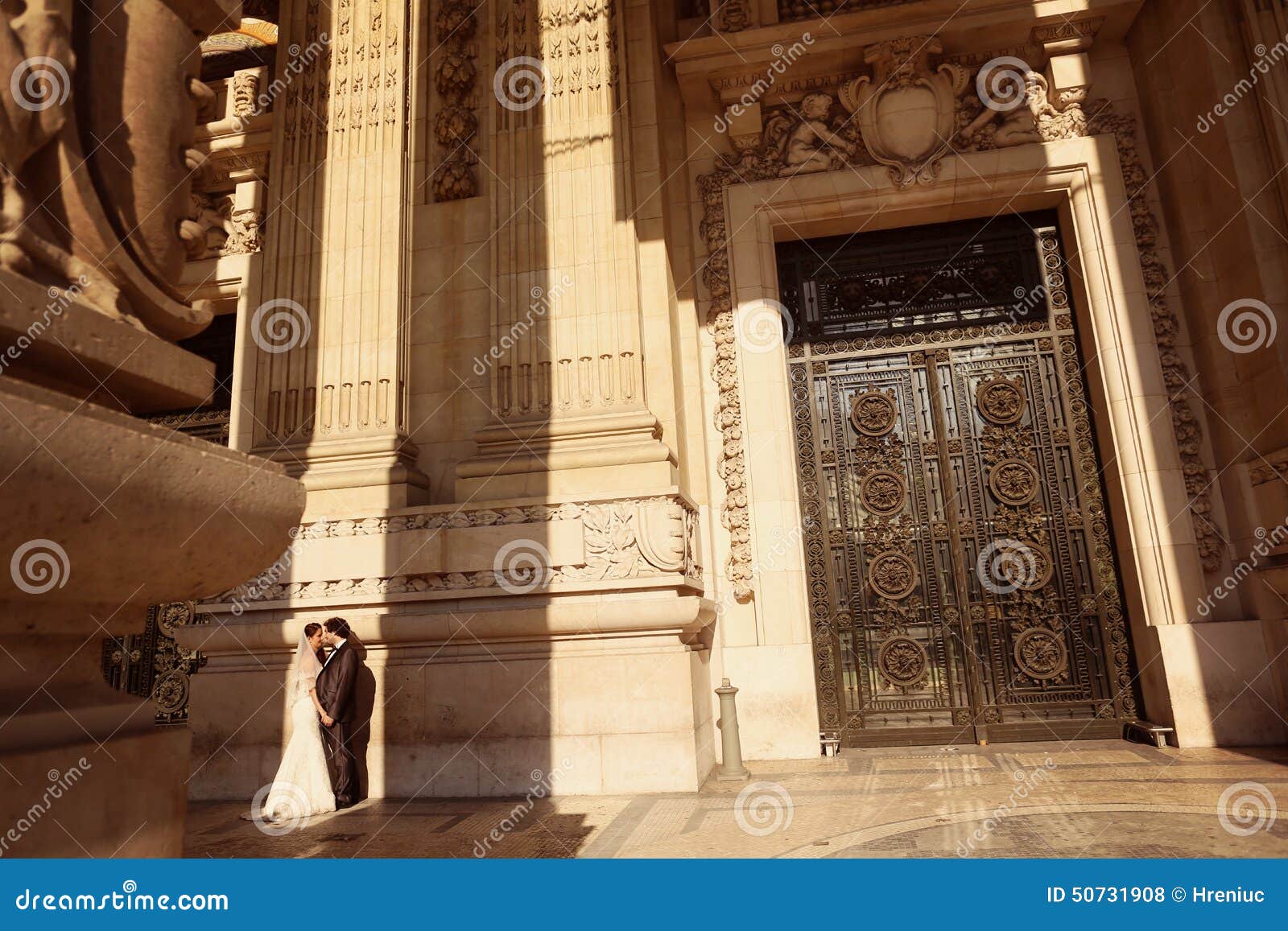 Bride And Groom In Front Of A Big Building Stock Photo