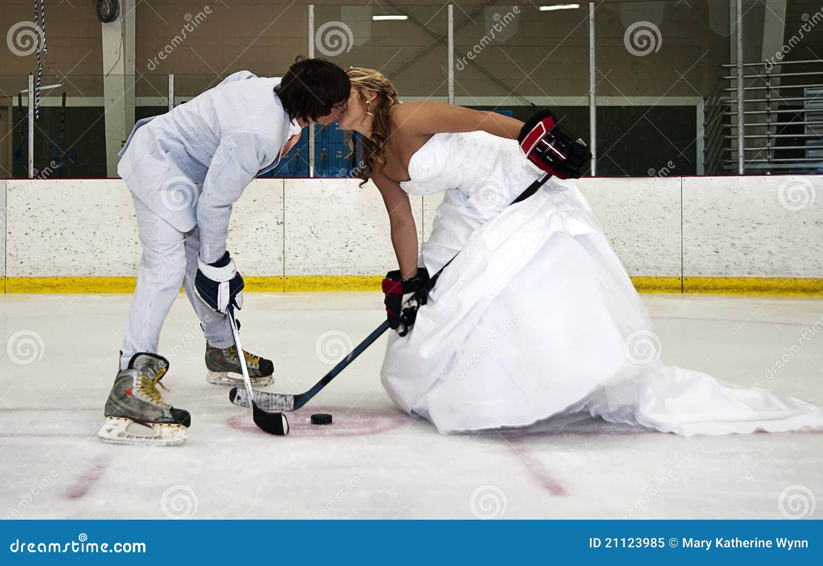 bride and groom hockey face off