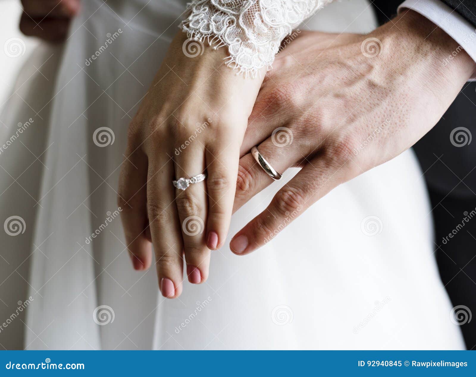 bride and groom showing their engagement wedding rings on hands