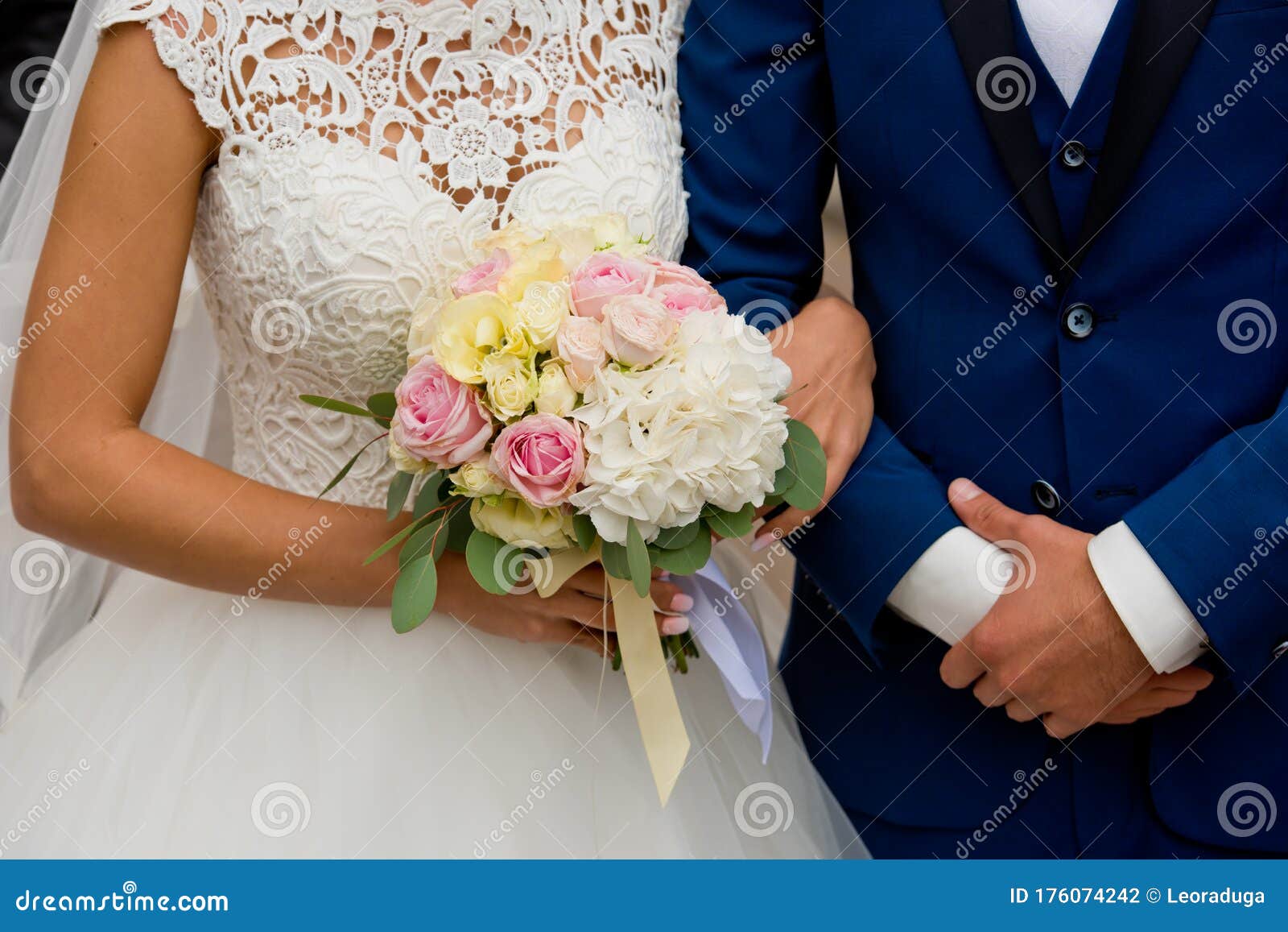 The Bride and Groom Stand with Their Hands Together. Stock Photo ...