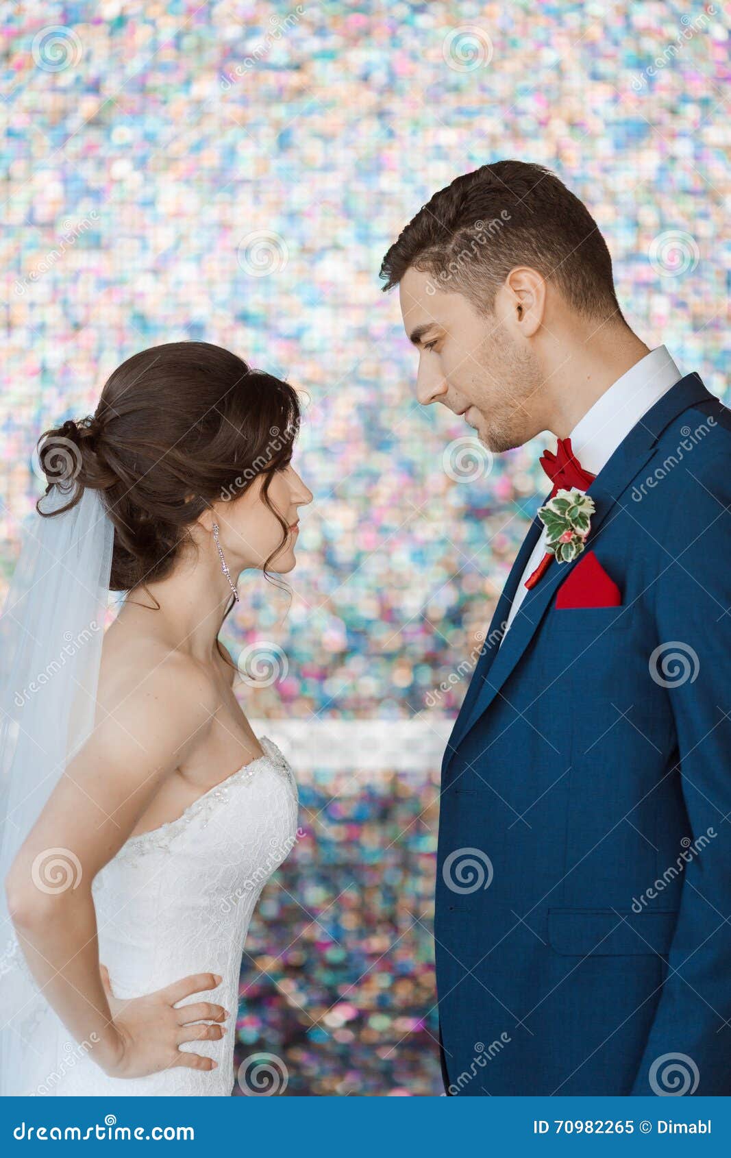 bride groom very bright colored room wedding couple rage beautiful white dress veil handsome blue suite standing angry 70982265