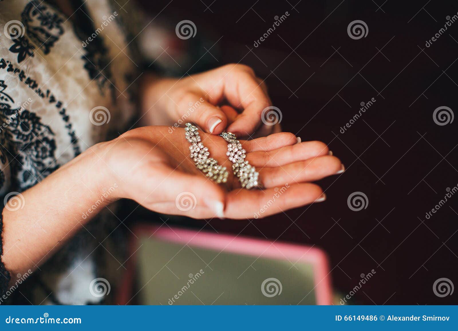 Bride is holding earrings stock photo. Image of bright 66149486