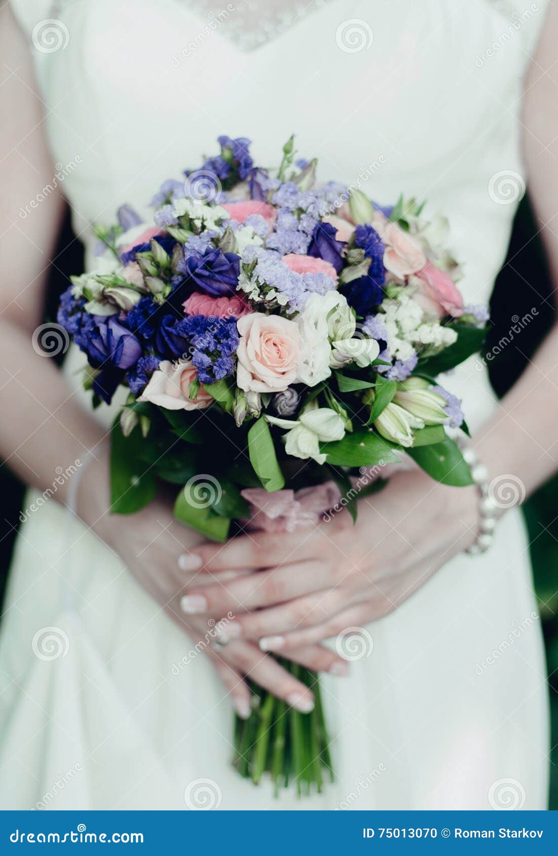 the bride holds a wedding bouquet
