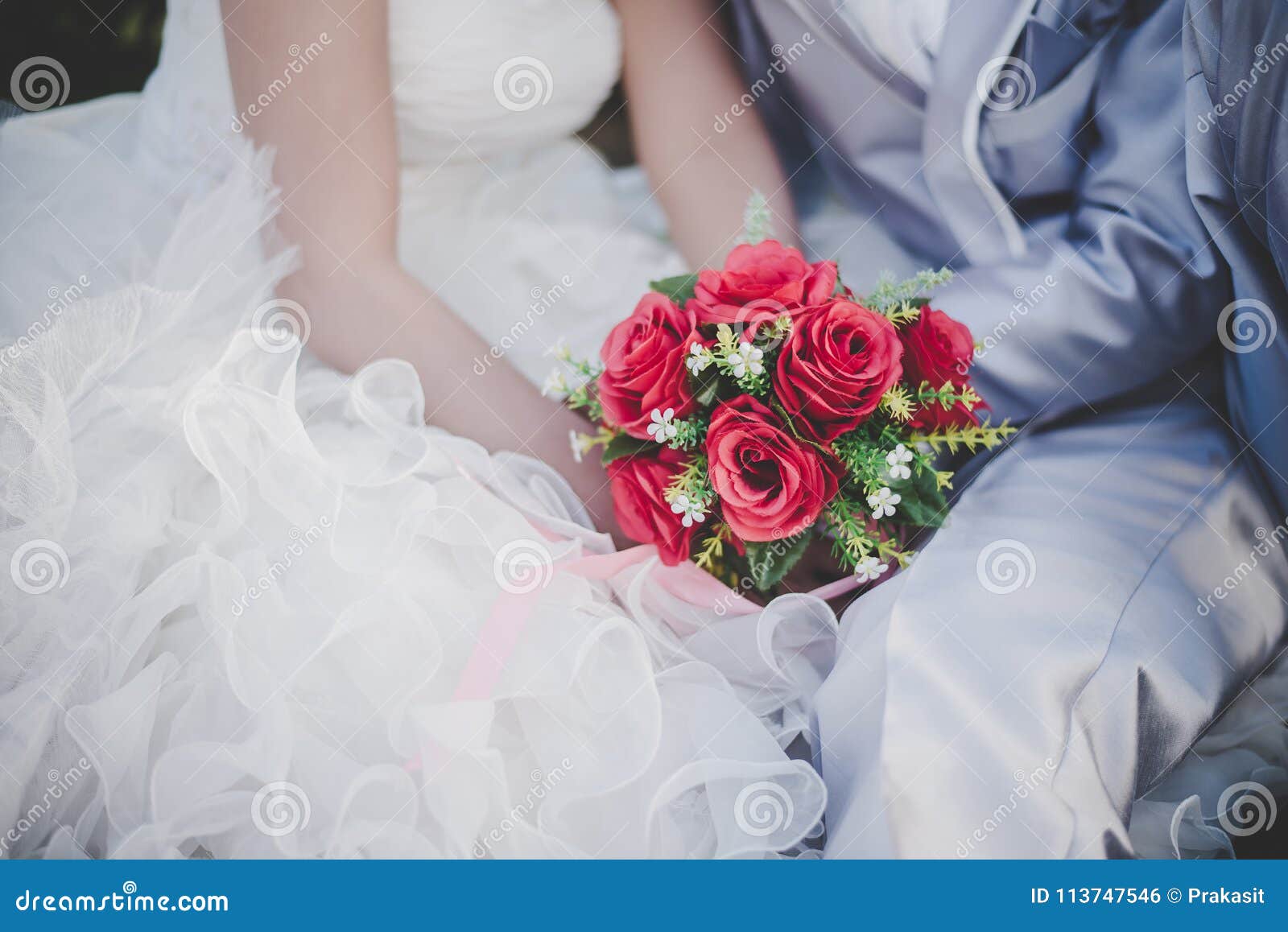 Bride Holds a Wedding Red Rose Bouquet in Hands, the Groom Hugs Stock ...