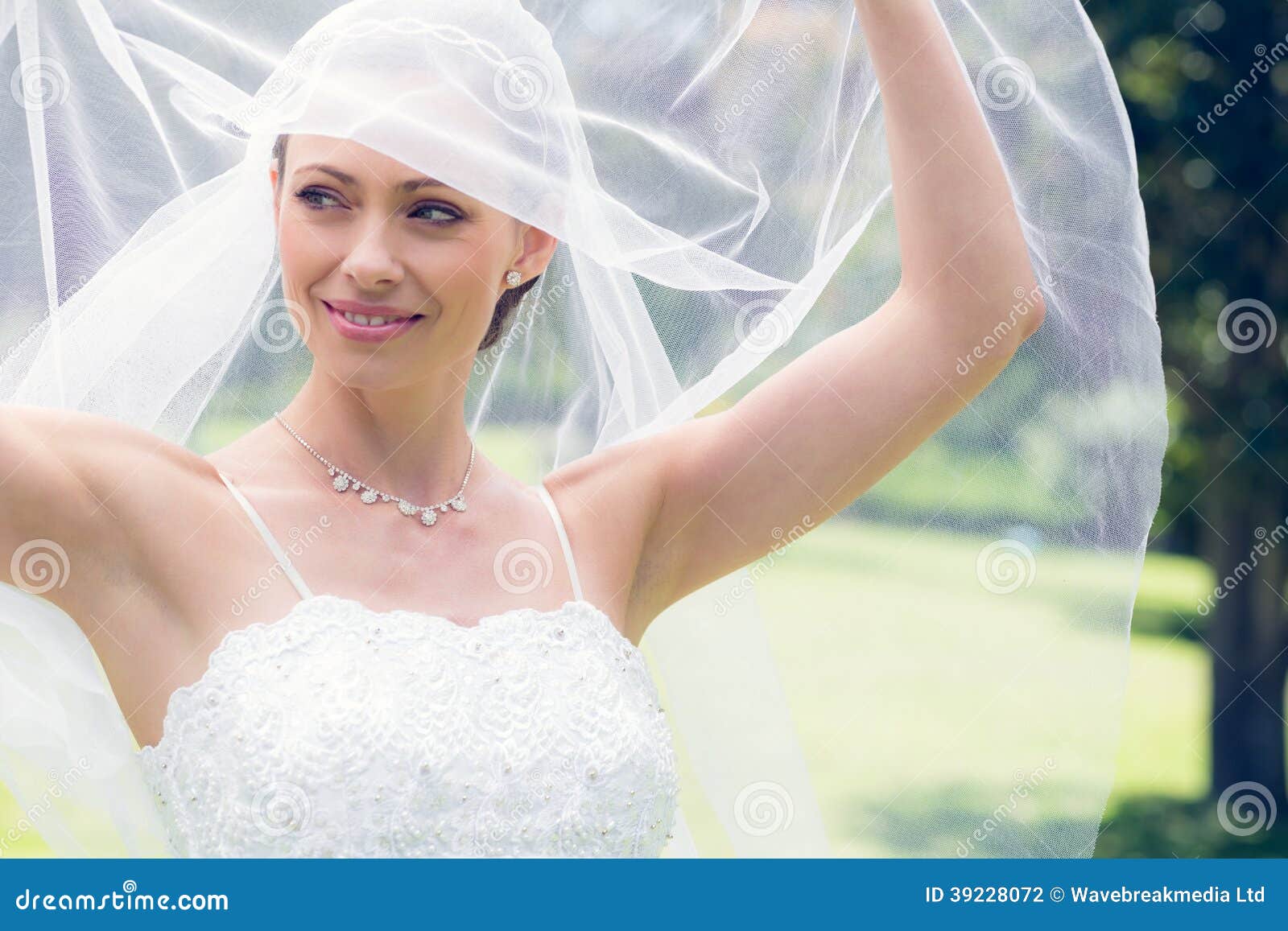 Bride Lifting Her Veil in Garden Stock Photo Image of caucasian