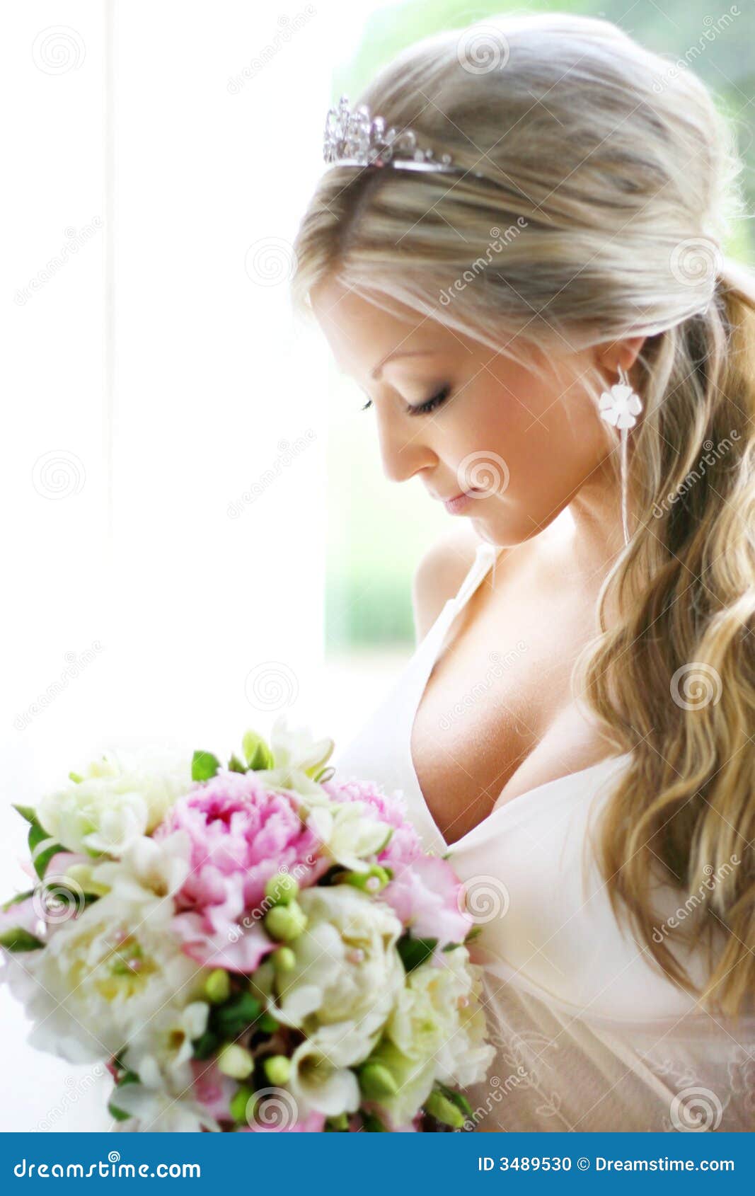 Bride looking at bouquet stock photo. Image of gazing Bride looking at bouquet stock photo. Image of gazing