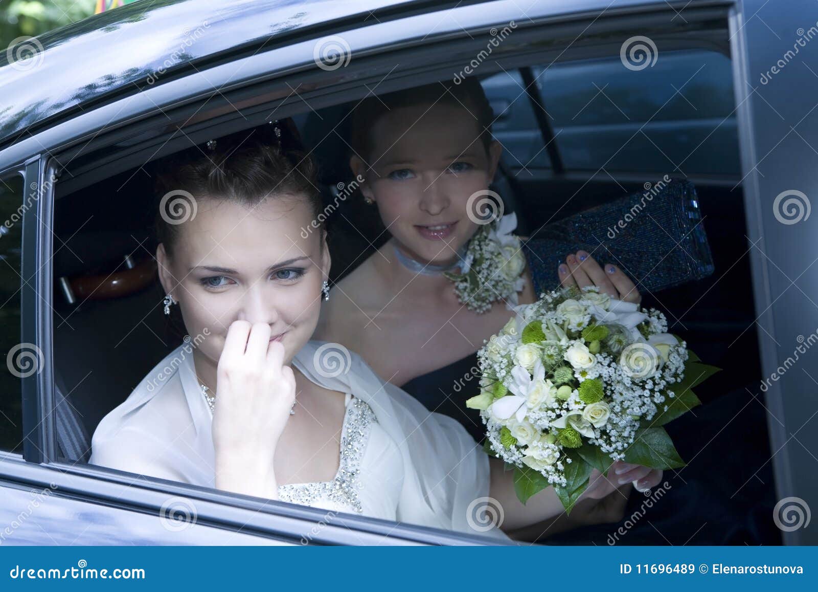 bride with maid of honour in the car