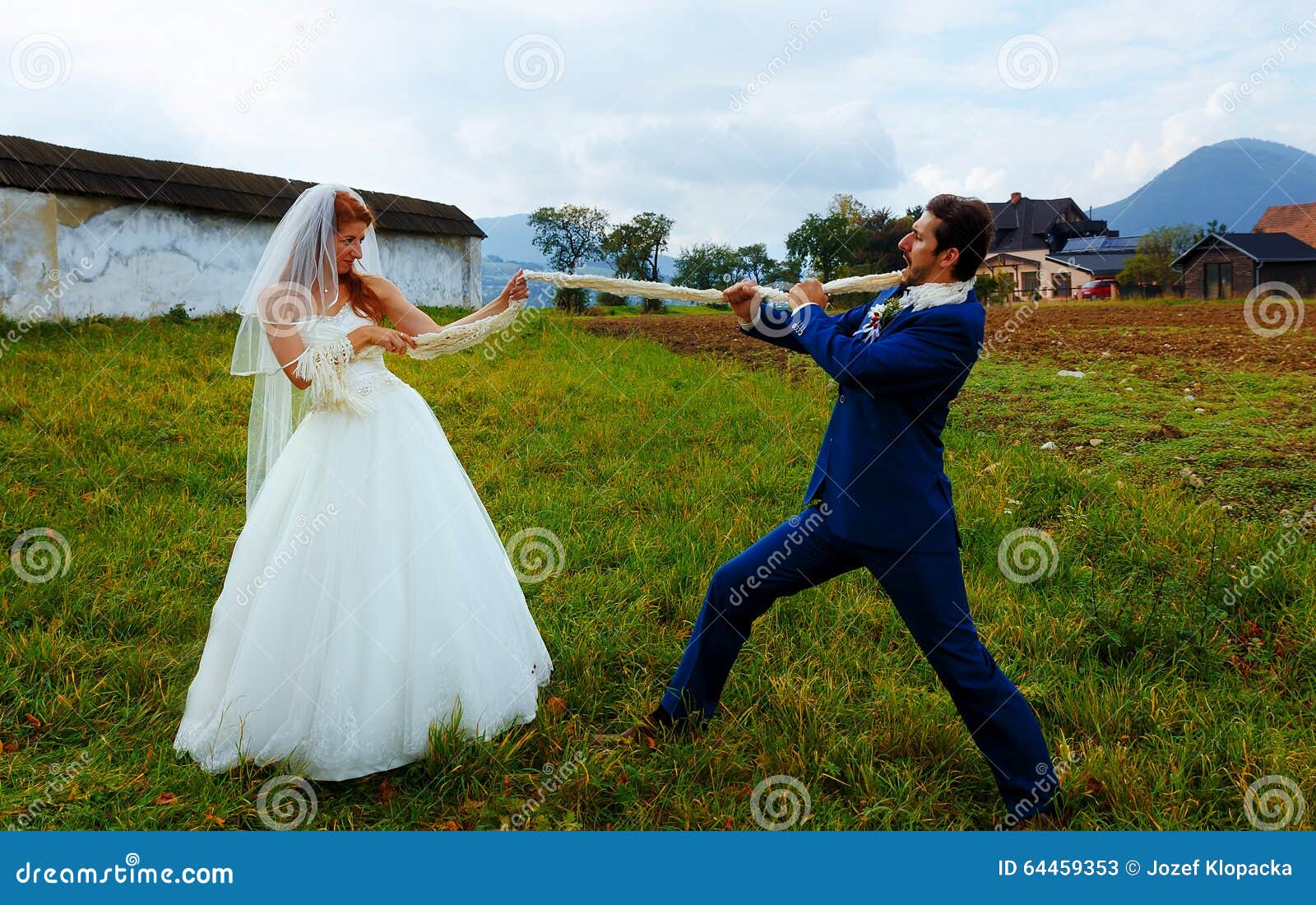 Bride Pulling Her Groom To Her with a Rope Funny Wedding Concept