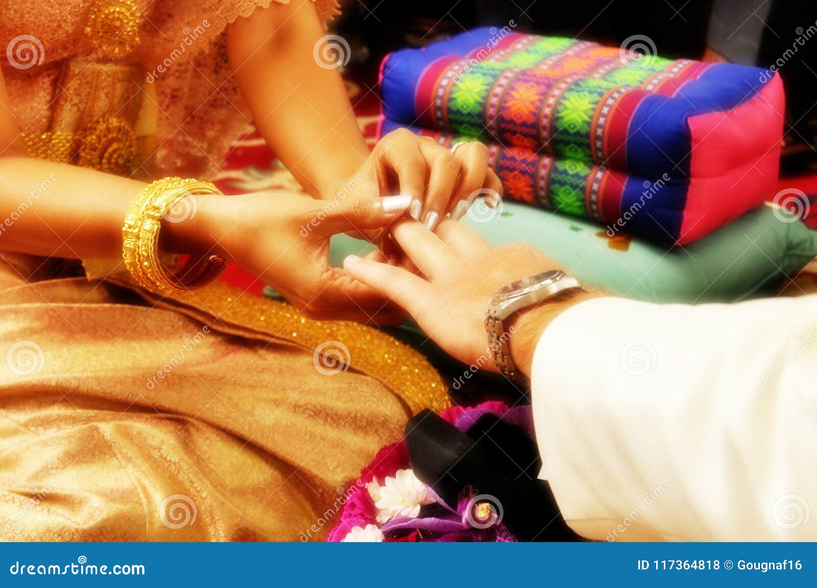 The Bride Puts the Ring on the Groom`s Finger during a Traditional Thai Wedding Stock Photo