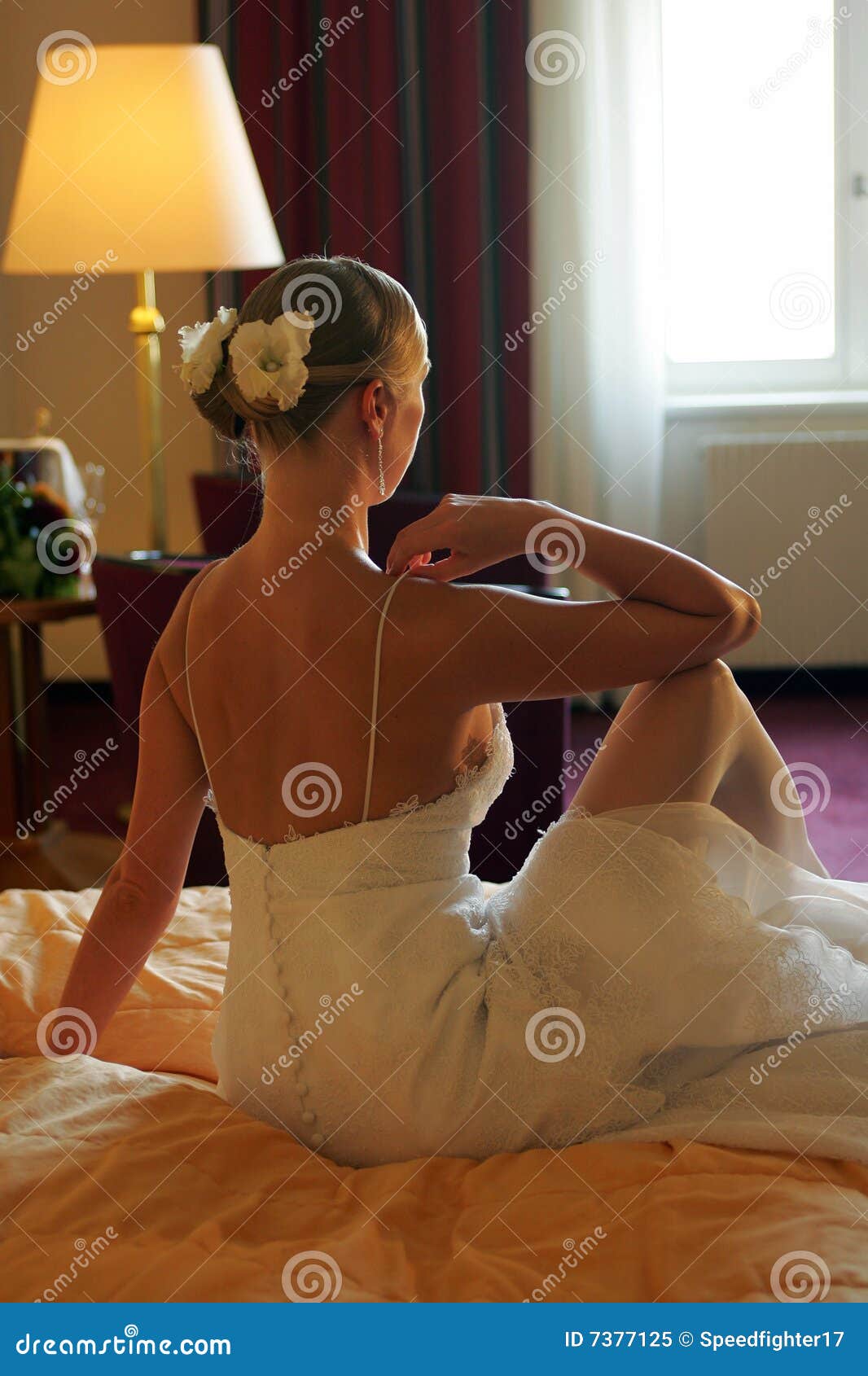 bride sat on bed rear view