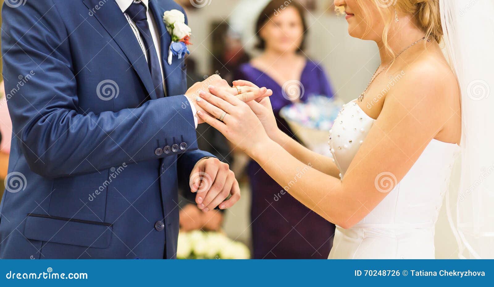 Bride Slipping Ring on Finger of Groom at Wedding Stock Photo Image
