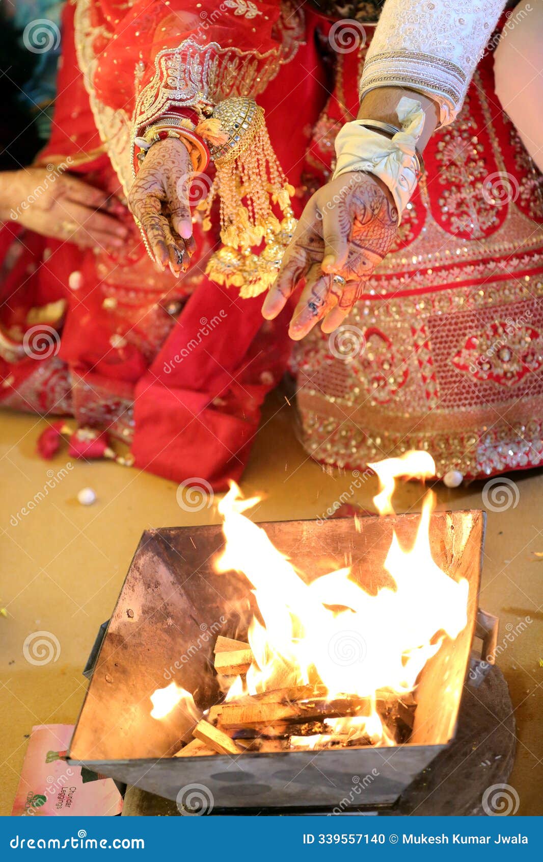 a bride in traditional attire performs a sacred ritual,