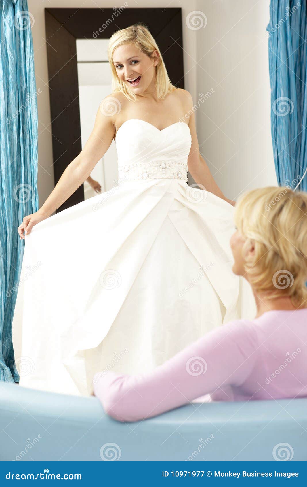 Bride Trying on Wedding Dress with Sales Assistant Stock Image Image
