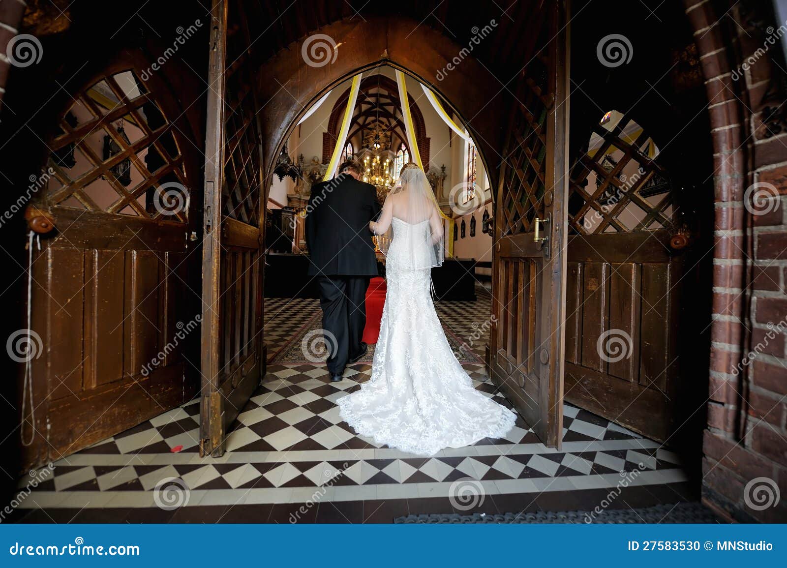 bride walking down aisle with father