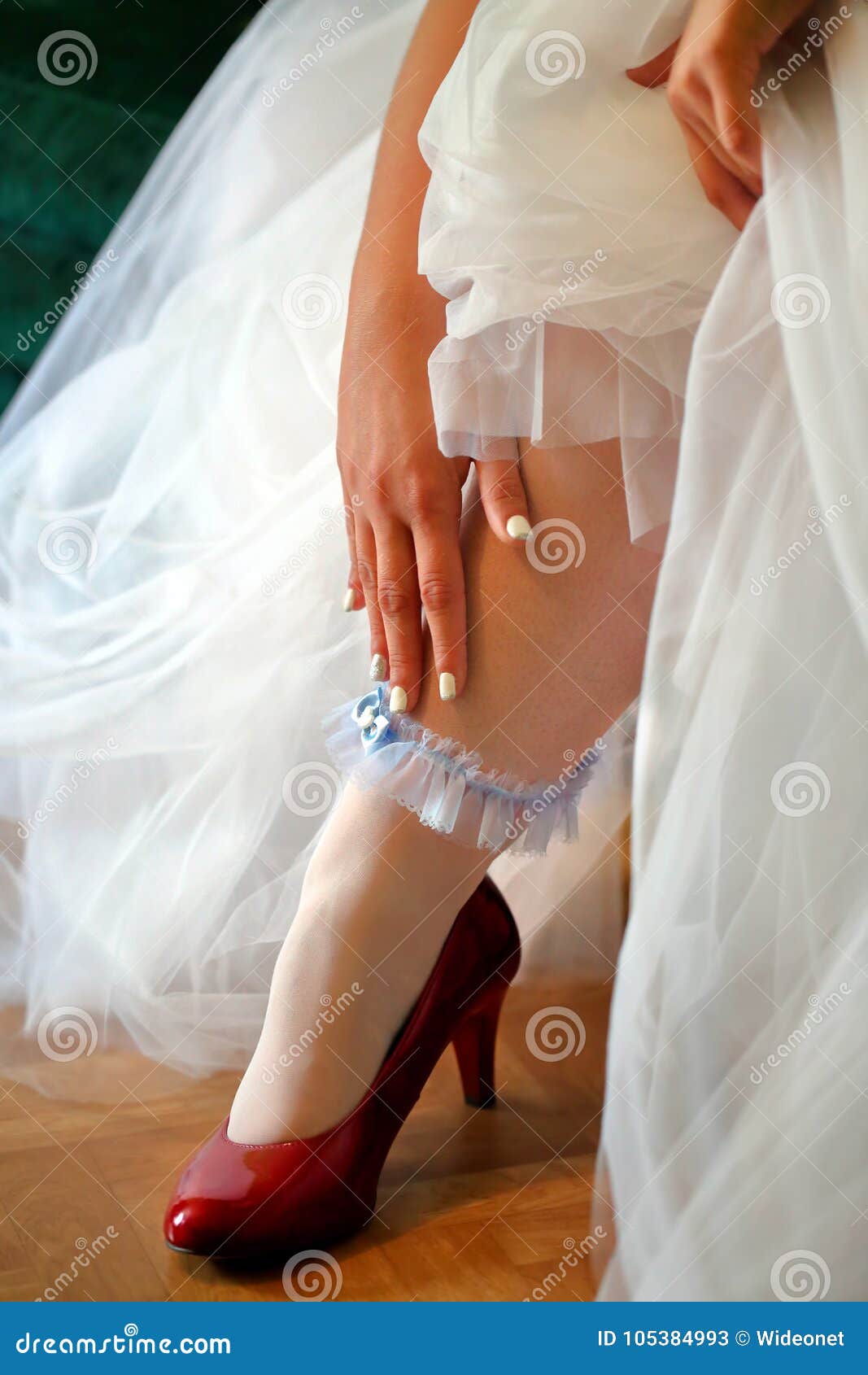 Bride Wearing Garter on Wedding Day Stock Image Image of women