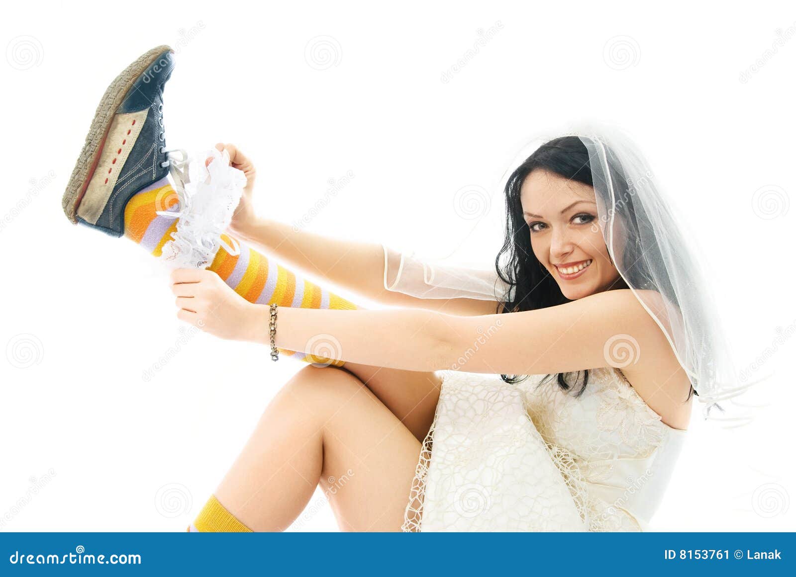 bride wearing sporting shoes puts on a garter
