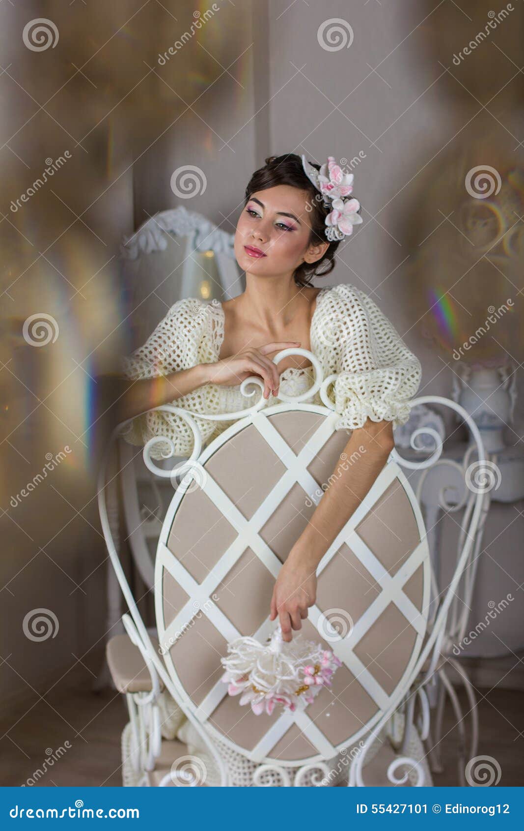 The bride in a white dress on the chair