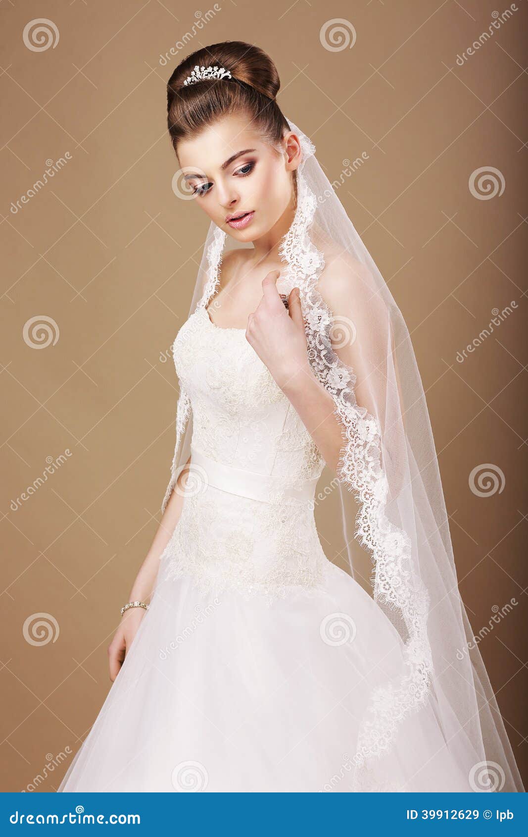 Femininity. Sentimental Bride in White Dress and Openwork Veil