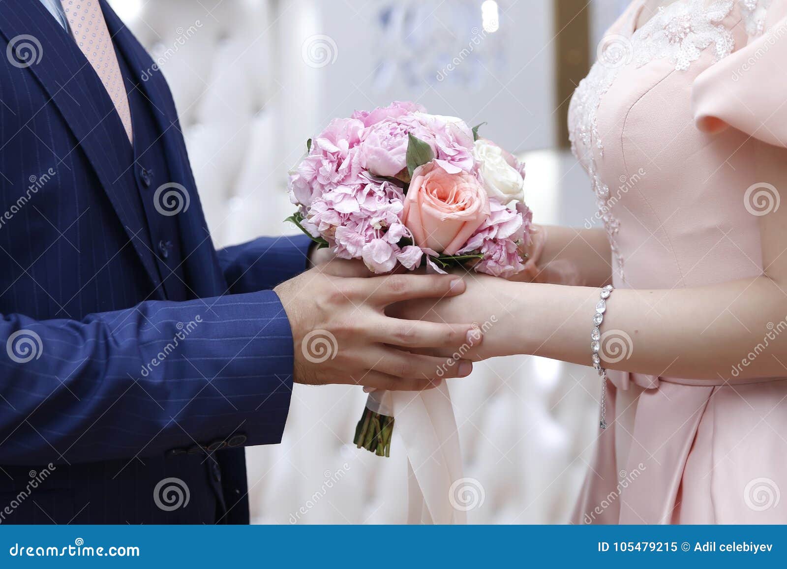 A Bride in a White Engagement Dress with a Bridal Bouquet in Her Hand ...