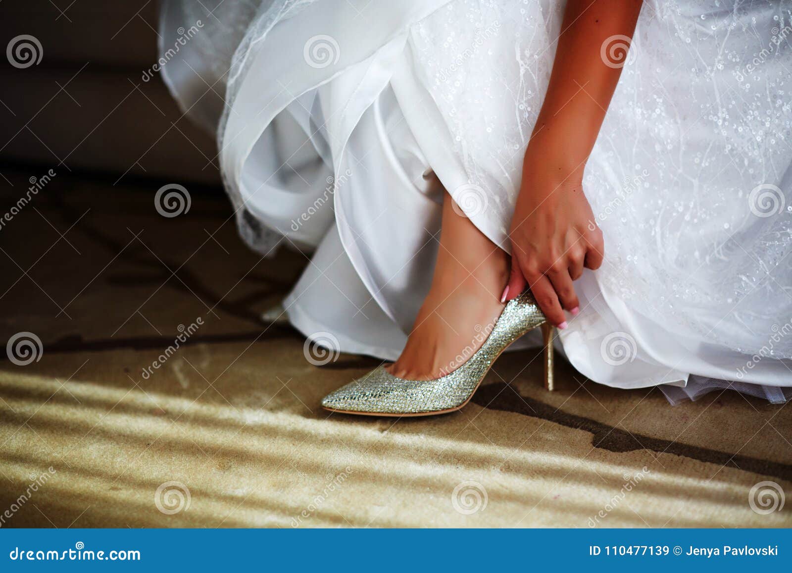 Bride in White Wedding Dress Putting on Silver Shoes Stock Image ...