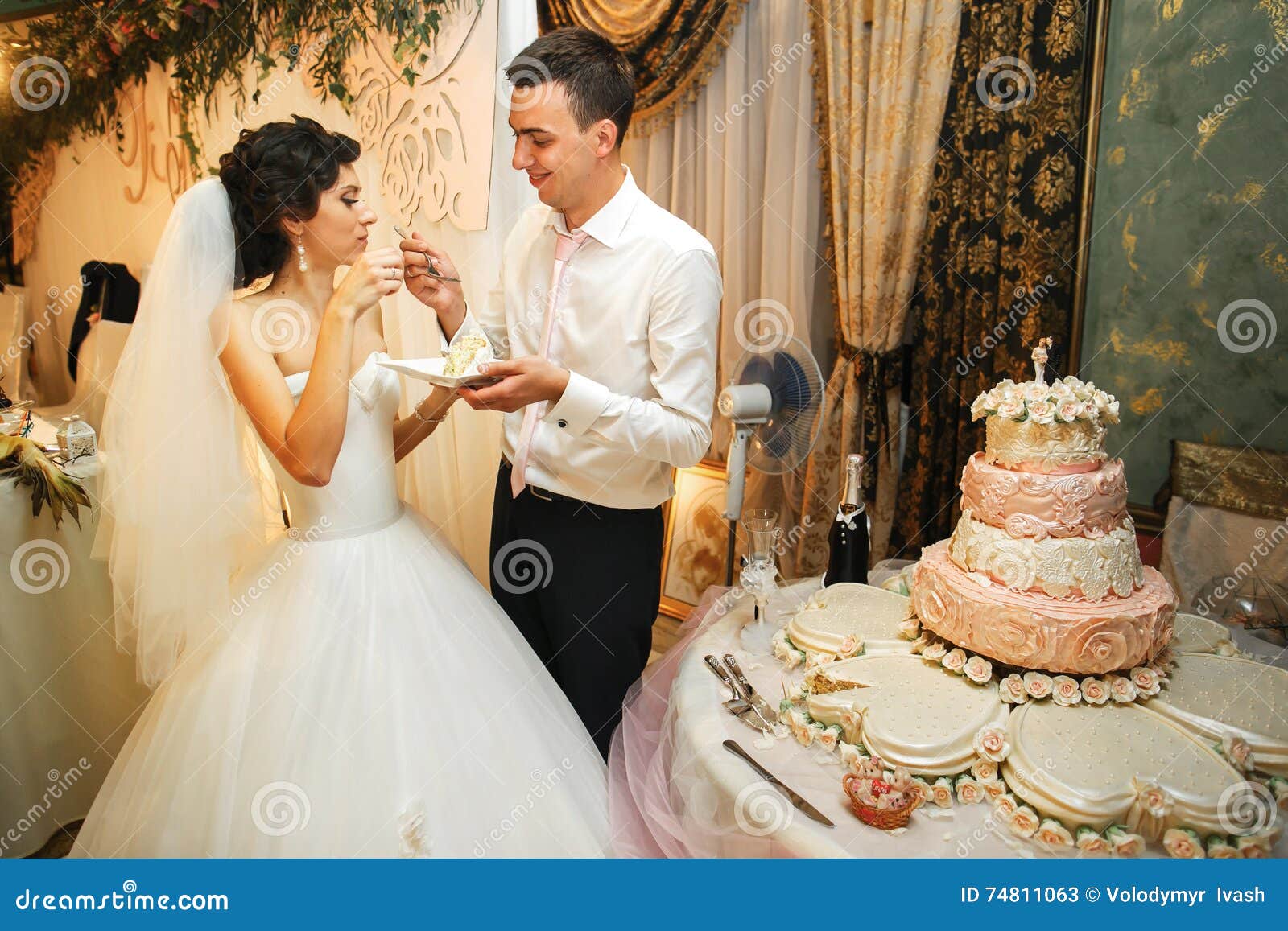 the brides eatting a wedding cake