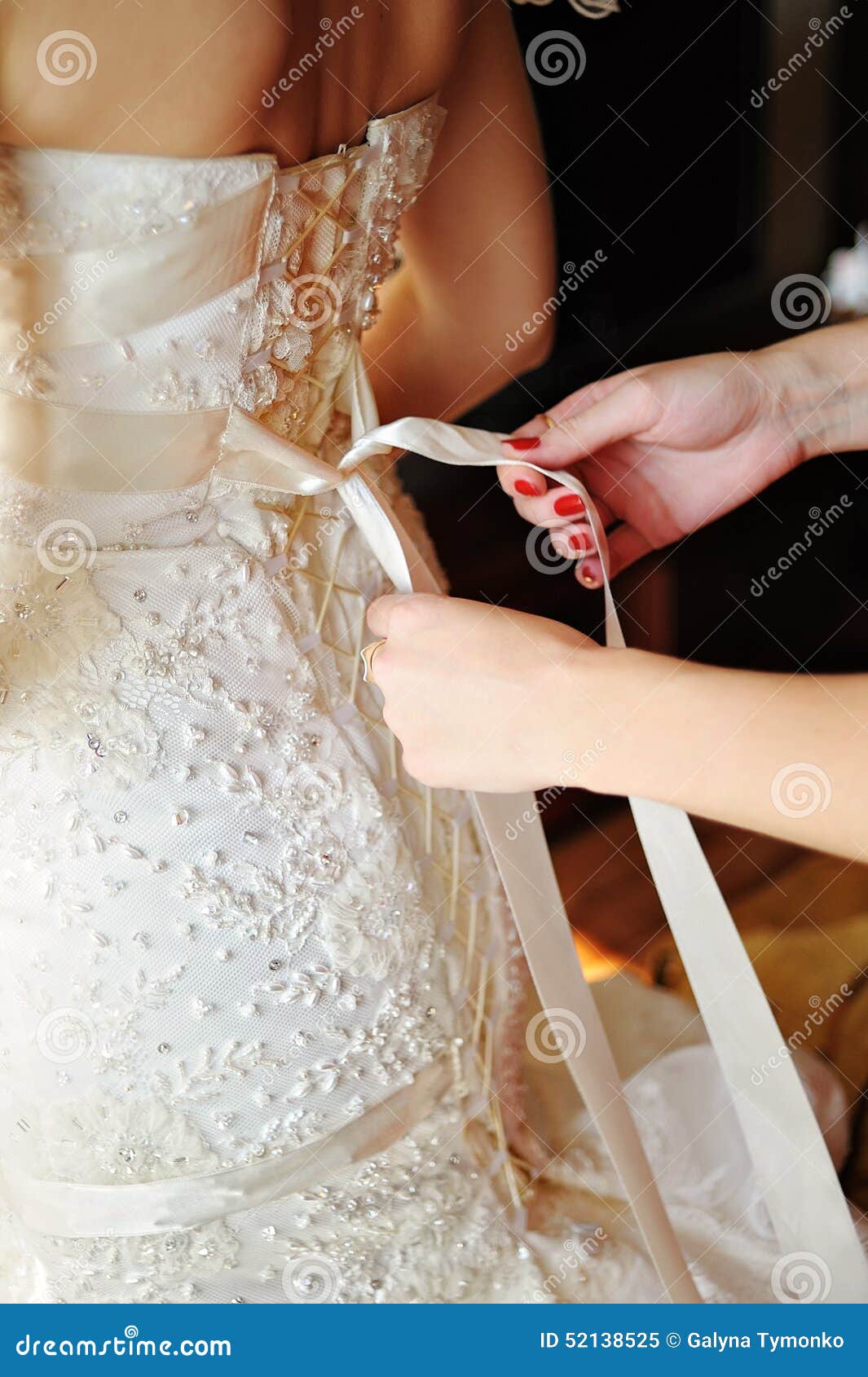 Bridesmaid Tying Bow on Wedding Dress Stock Image Image of finger