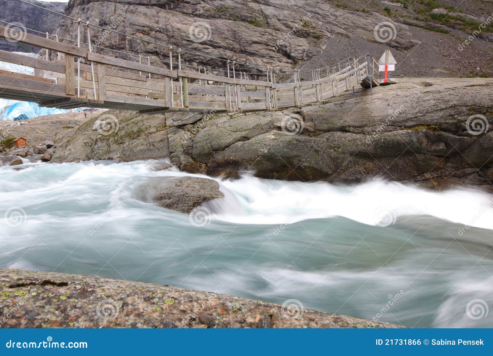 bridge over rapid runoff water from glacier