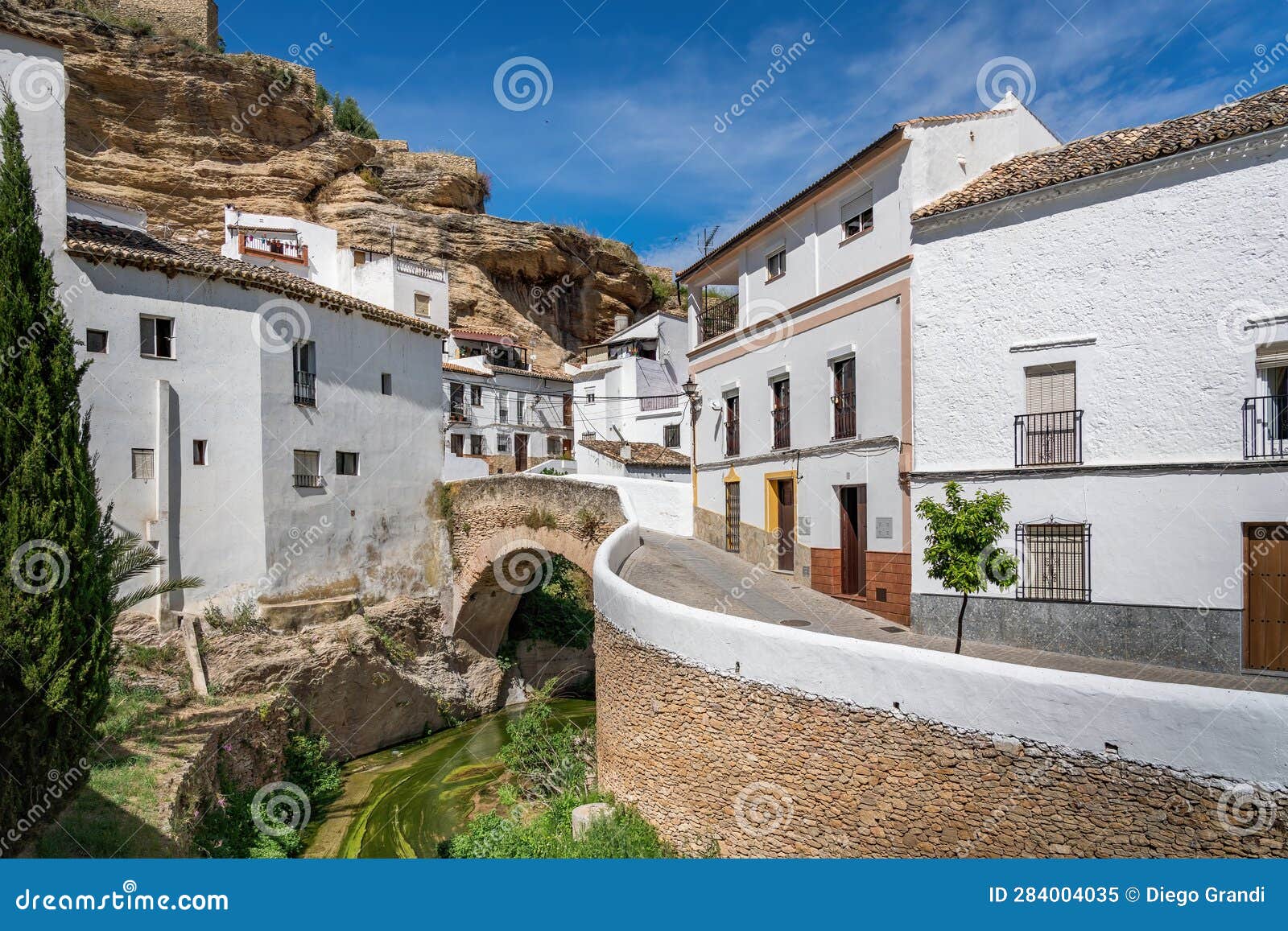 bridge over trejo river and rock overhangs - setenil de las bodegas, andalusia, spain
