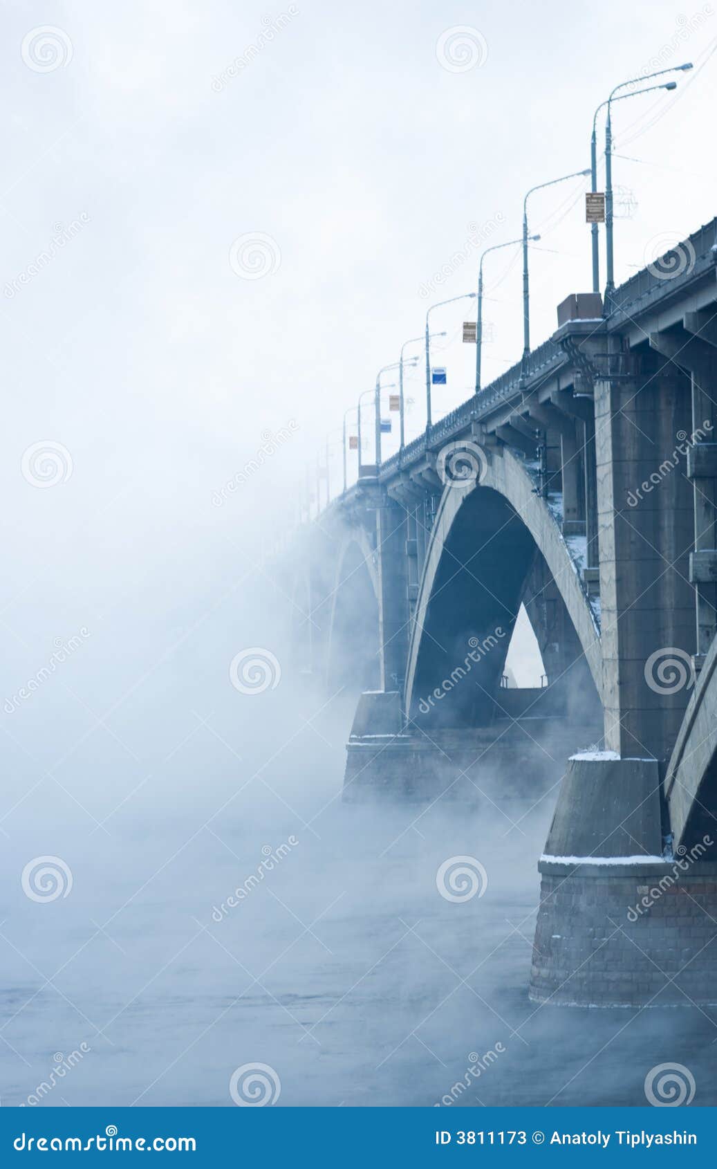 Bridge on river in cold steam on blue