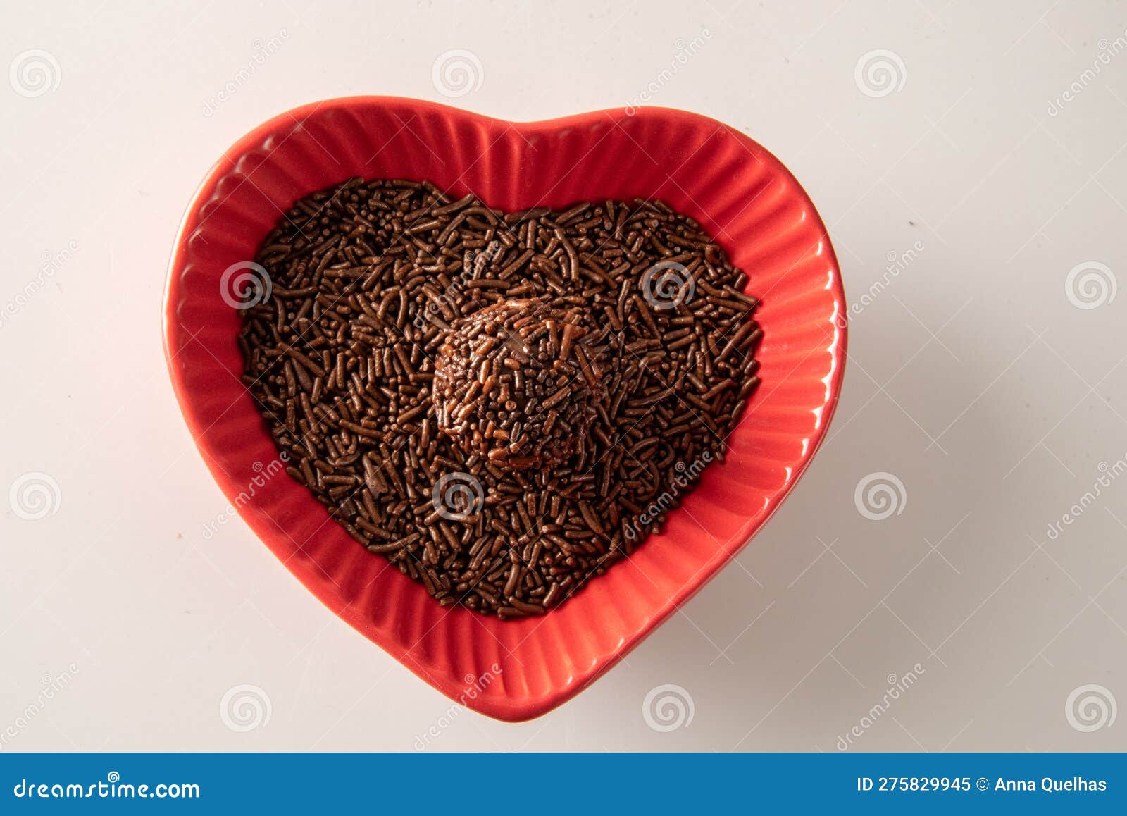 brigadeiro over a red heart d bowl i  on white background