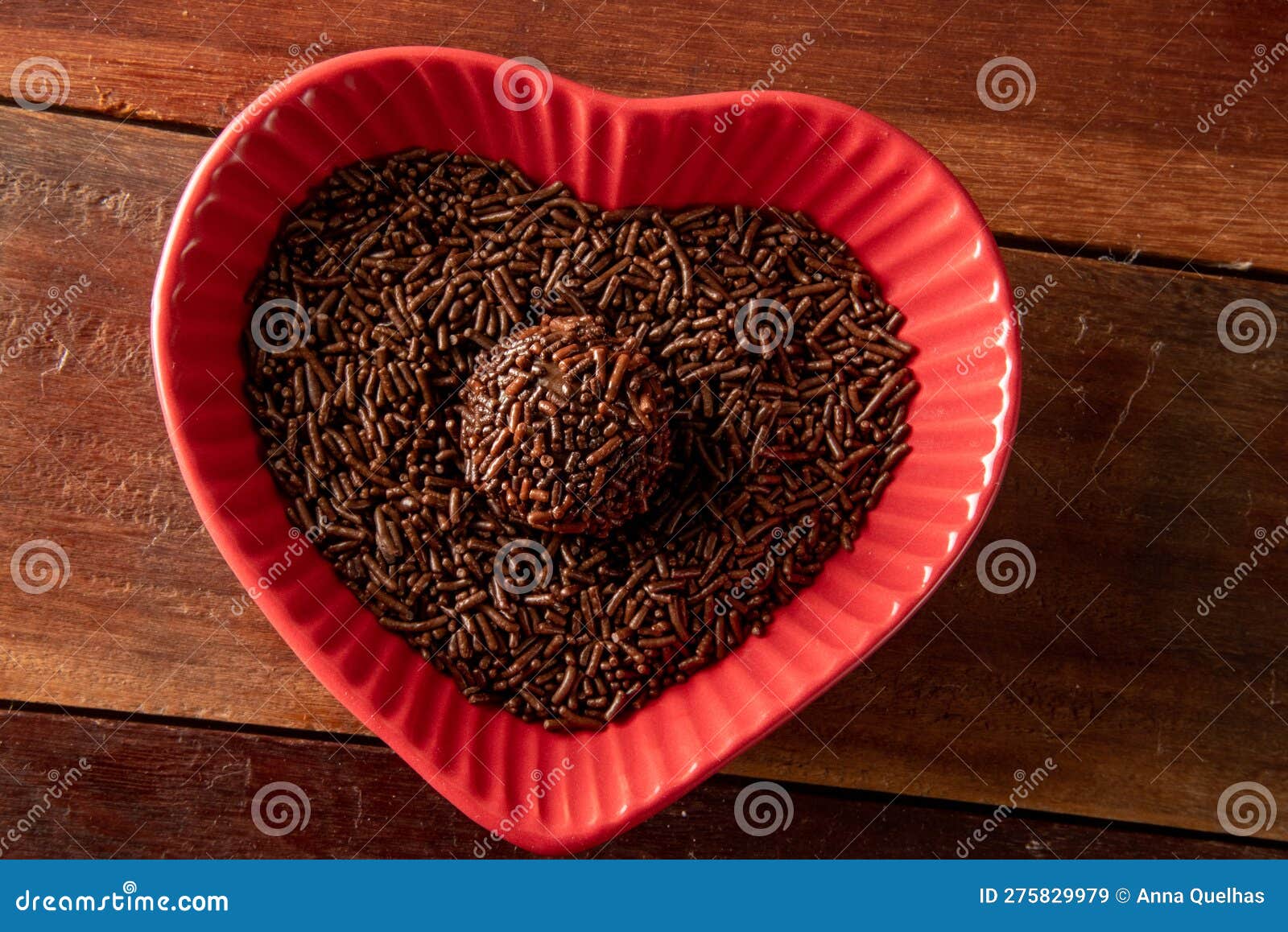 brigadeiro over a red heart d bowl and wooden background