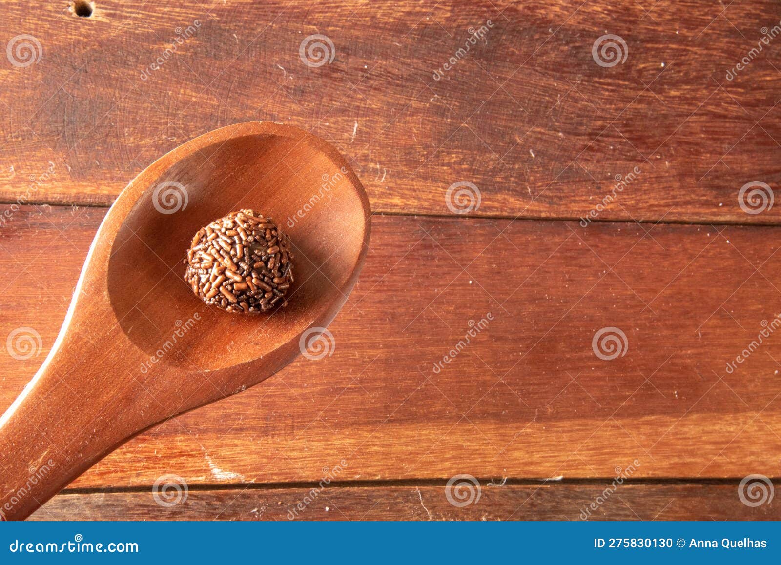 brigadeiro in wooden spoon on wooden background