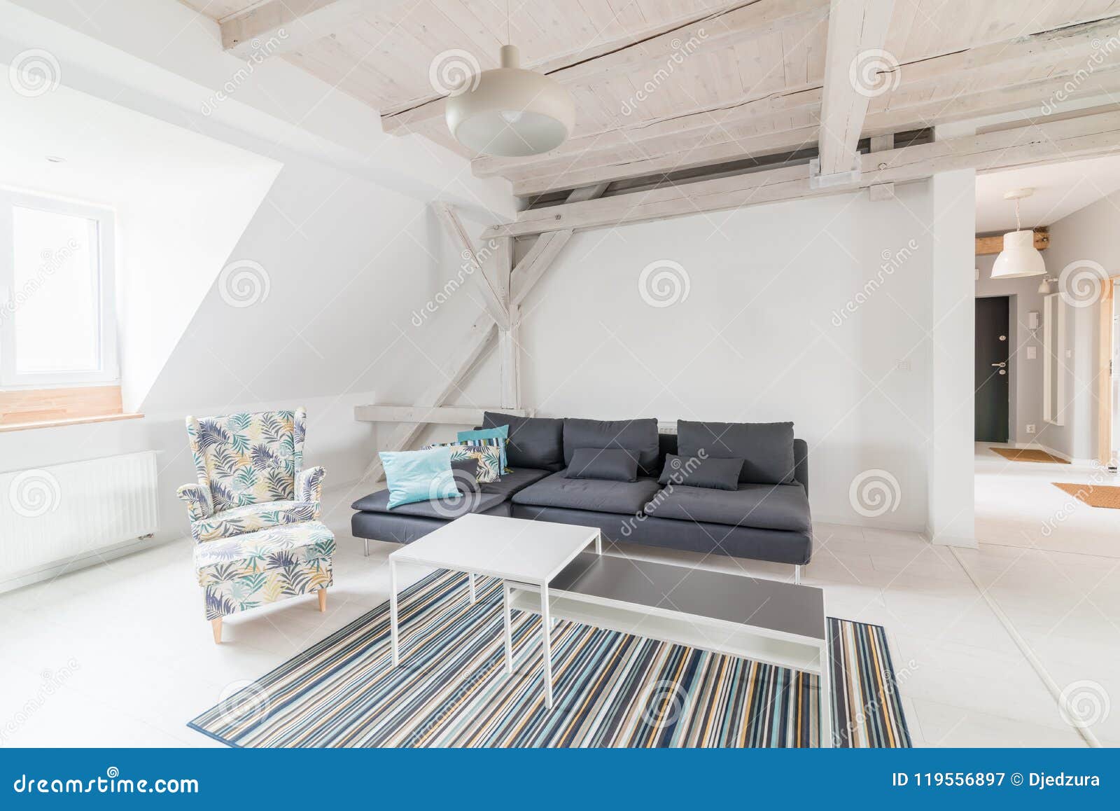 Bright Attic Living Room With Wooden Ceiling Beams Stock